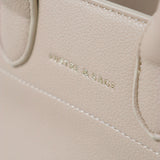 Clemence Pebbled Handbag in Stone